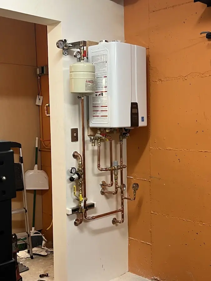 Plumbing technician inspecting water heater connections in Coronado